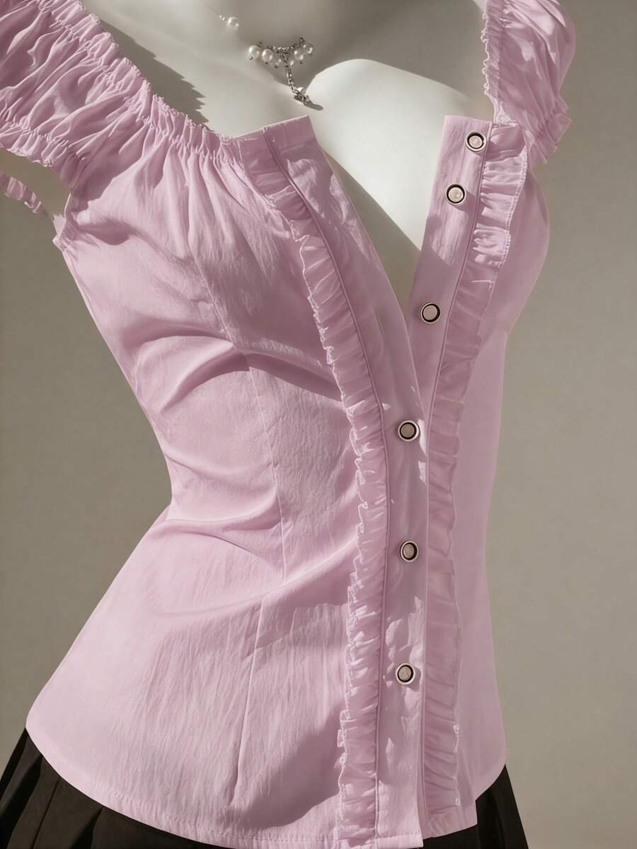 Women's black off-shoulder cap sleeve blouse with ruffled detailing and a tie-back design.
