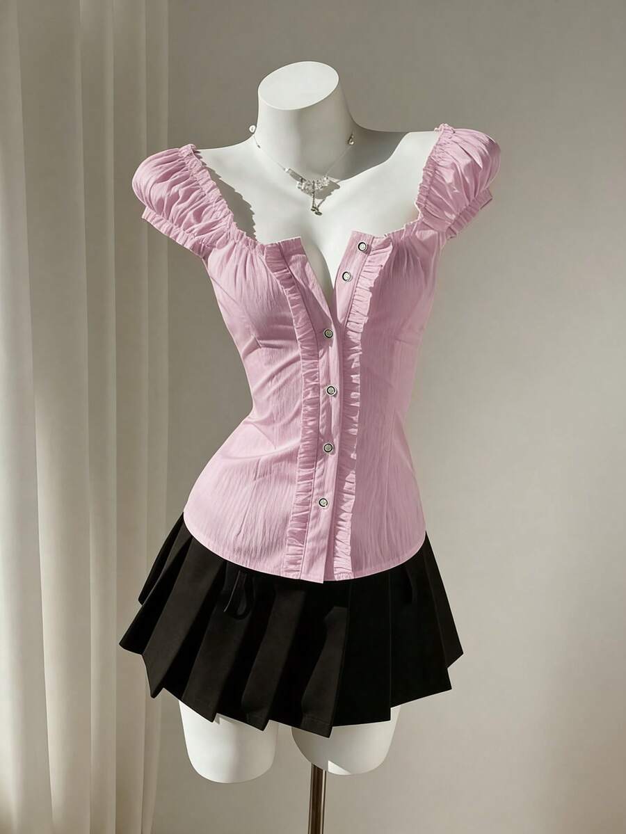 Women's black off-shoulder cap sleeve blouse with ruffled detailing and a tie-back design.