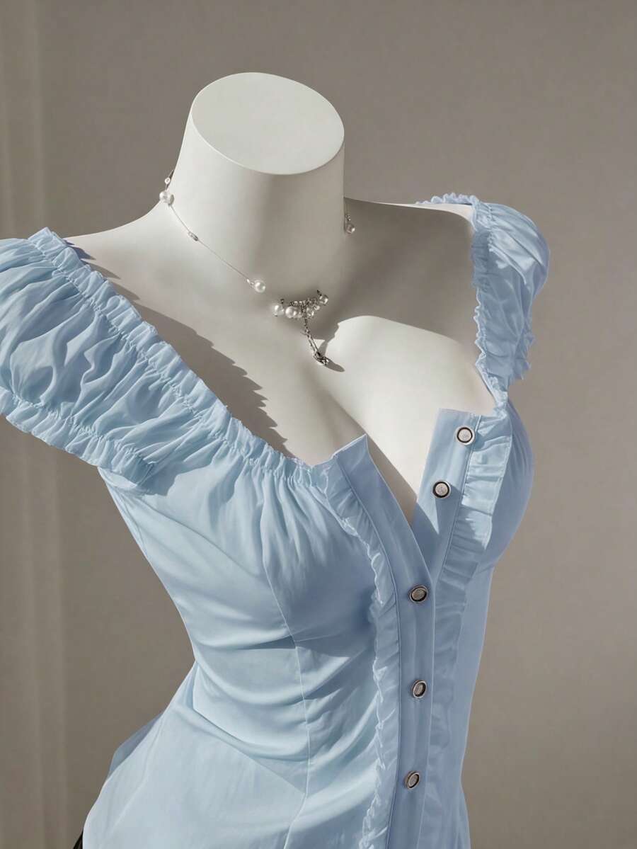 Women's black off-shoulder cap sleeve blouse with ruffled detailing and a tie-back design.