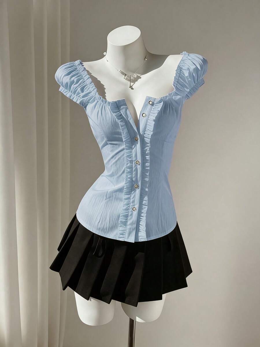 Women's black off-shoulder cap sleeve blouse with ruffled detailing and a tie-back design.