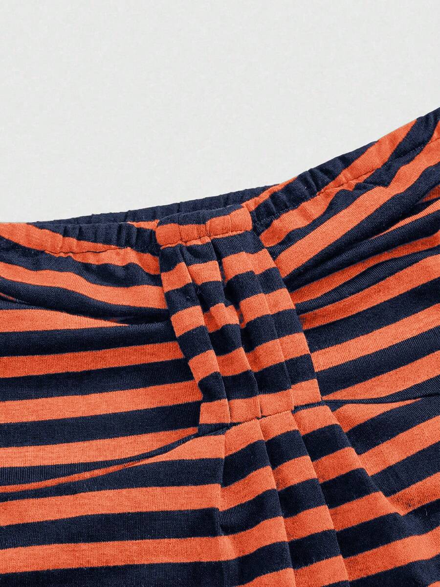 Women's striped strapless tube top featuring ruched detailing, flared hem, and stretchy knit fabric.