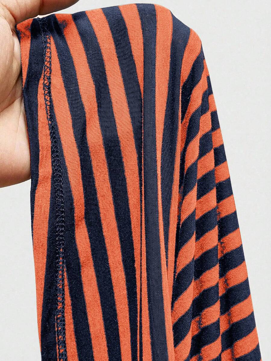 Women's striped strapless tube top featuring ruched detailing, flared hem, and stretchy knit fabric.