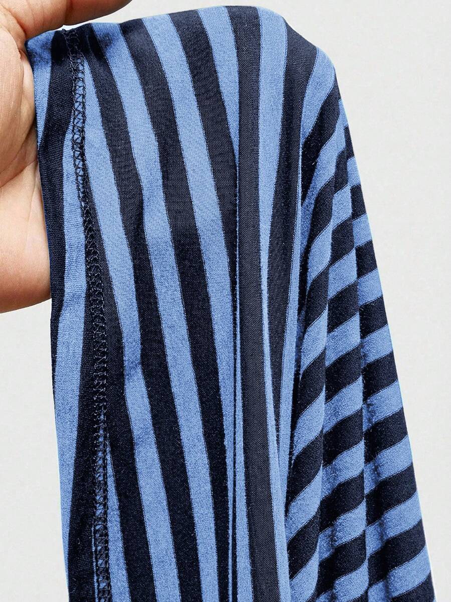 Women's striped strapless tube top featuring ruched detailing, flared hem, and stretchy knit fabric.