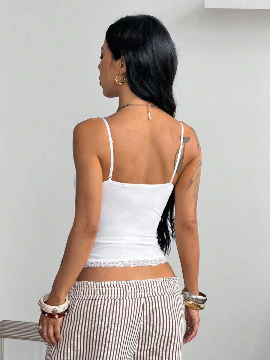 White slim fit lace tank top with spaghetti straps and floral lace pattern