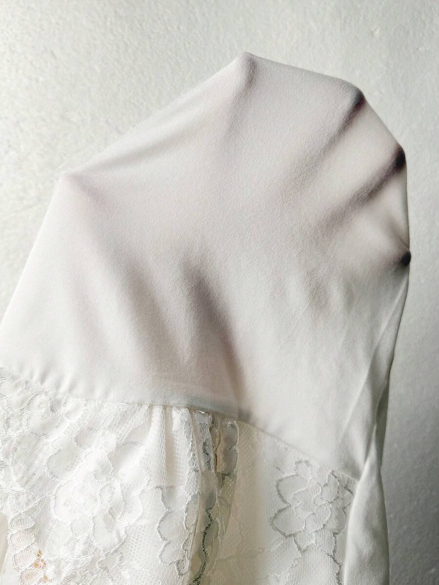 White slim fit lace tank top with spaghetti straps and floral lace pattern