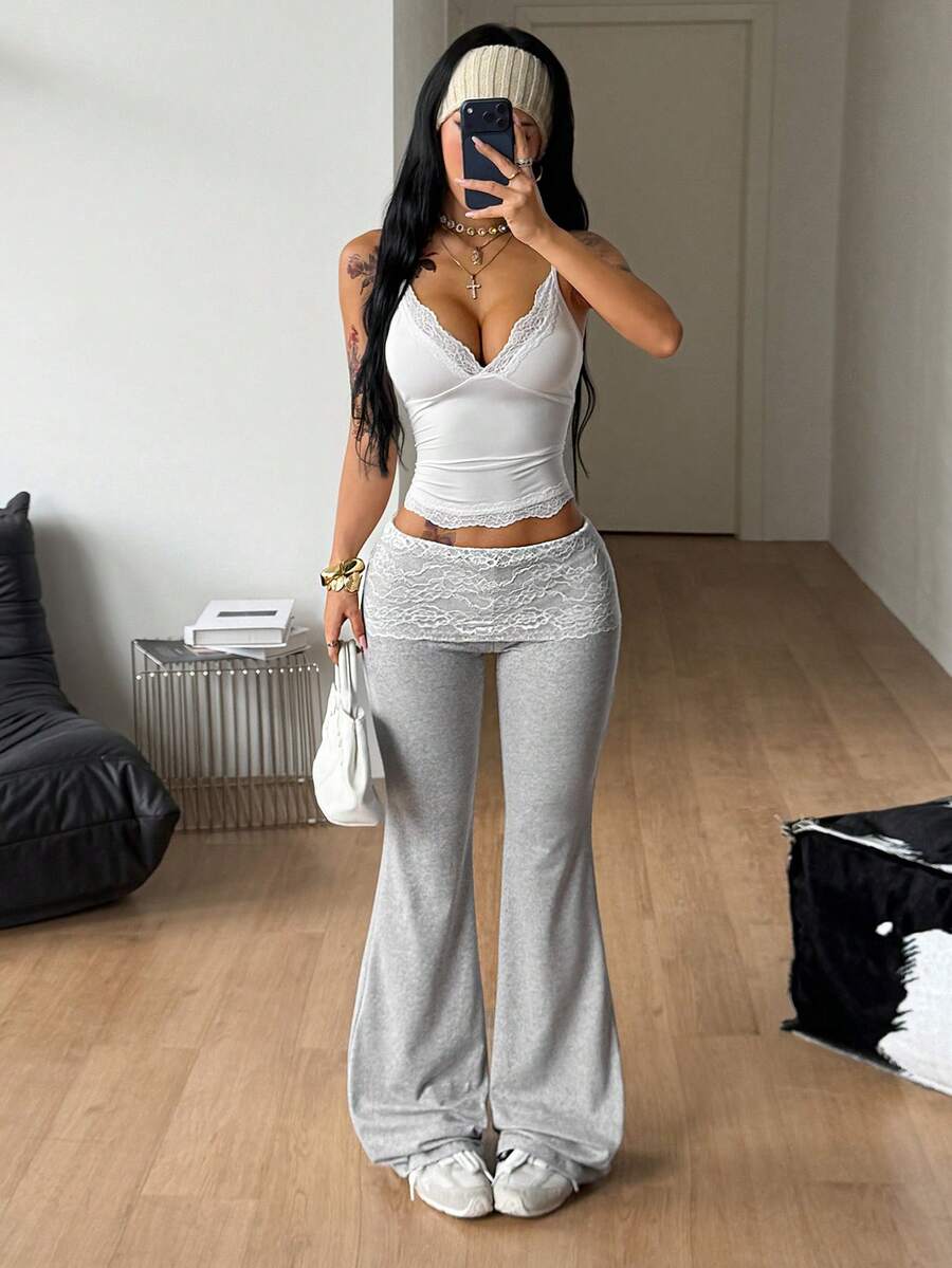 Women's black and white polka dot flare leg pants with side drawstring and ruched details