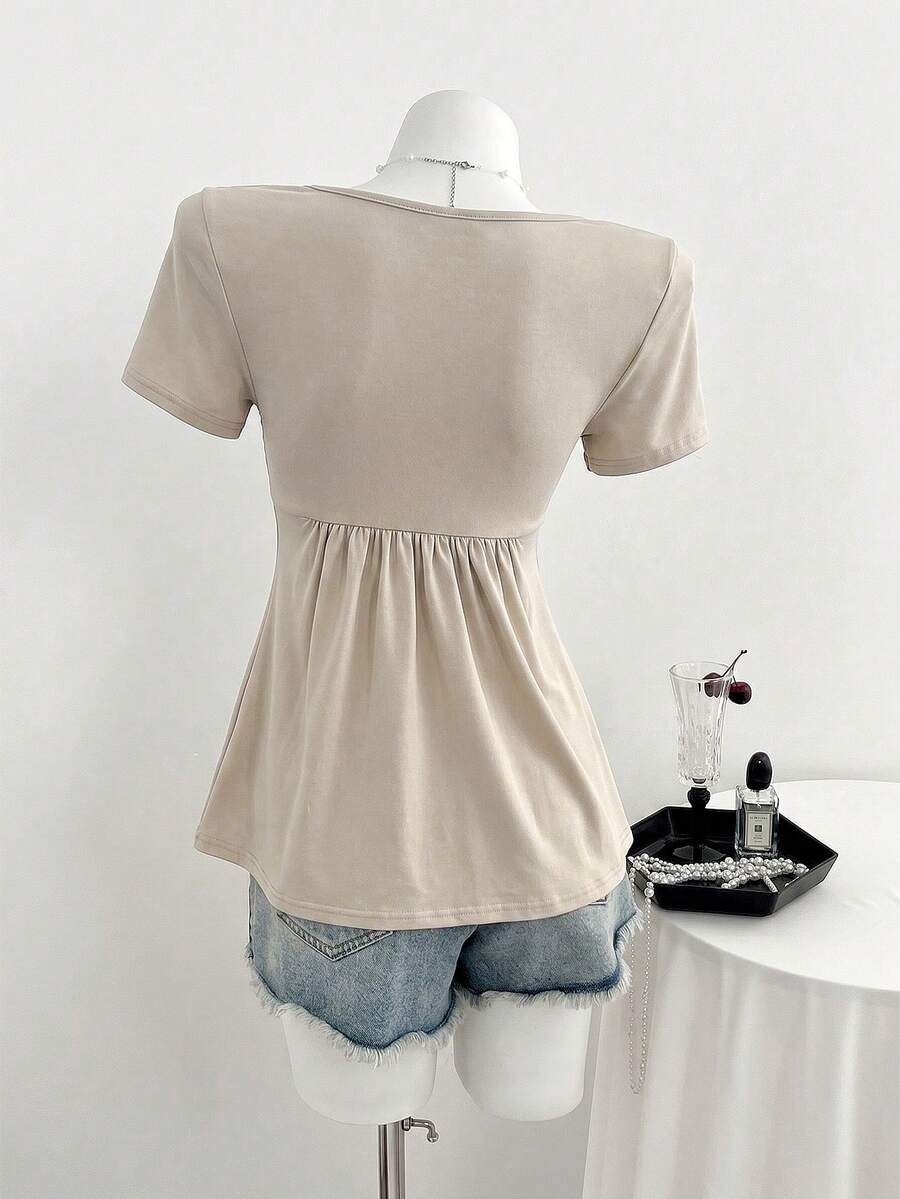 Women's short sleeve V-neck T-shirt featuring a front twist knot detail and slim fit.
