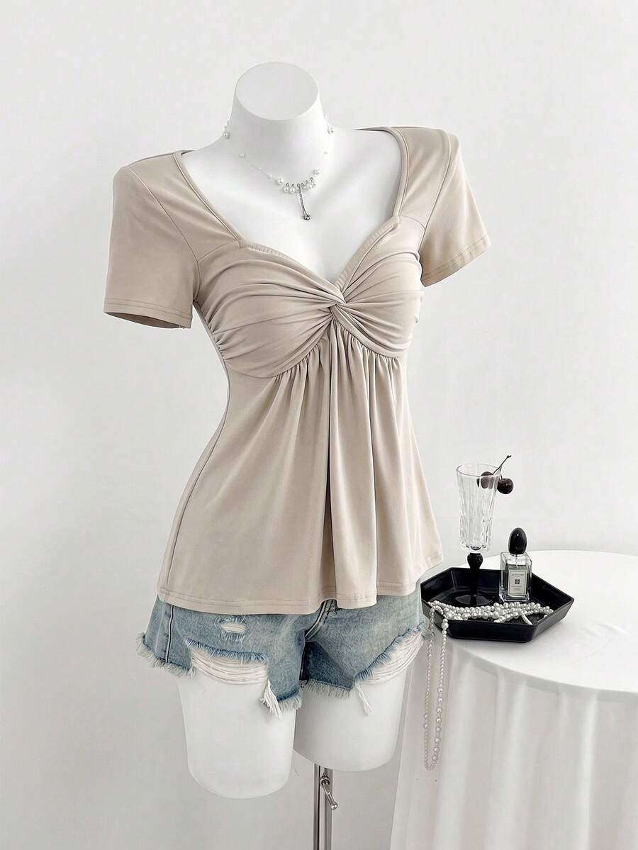 Women's short sleeve V-neck T-shirt featuring a front twist knot detail and slim fit.