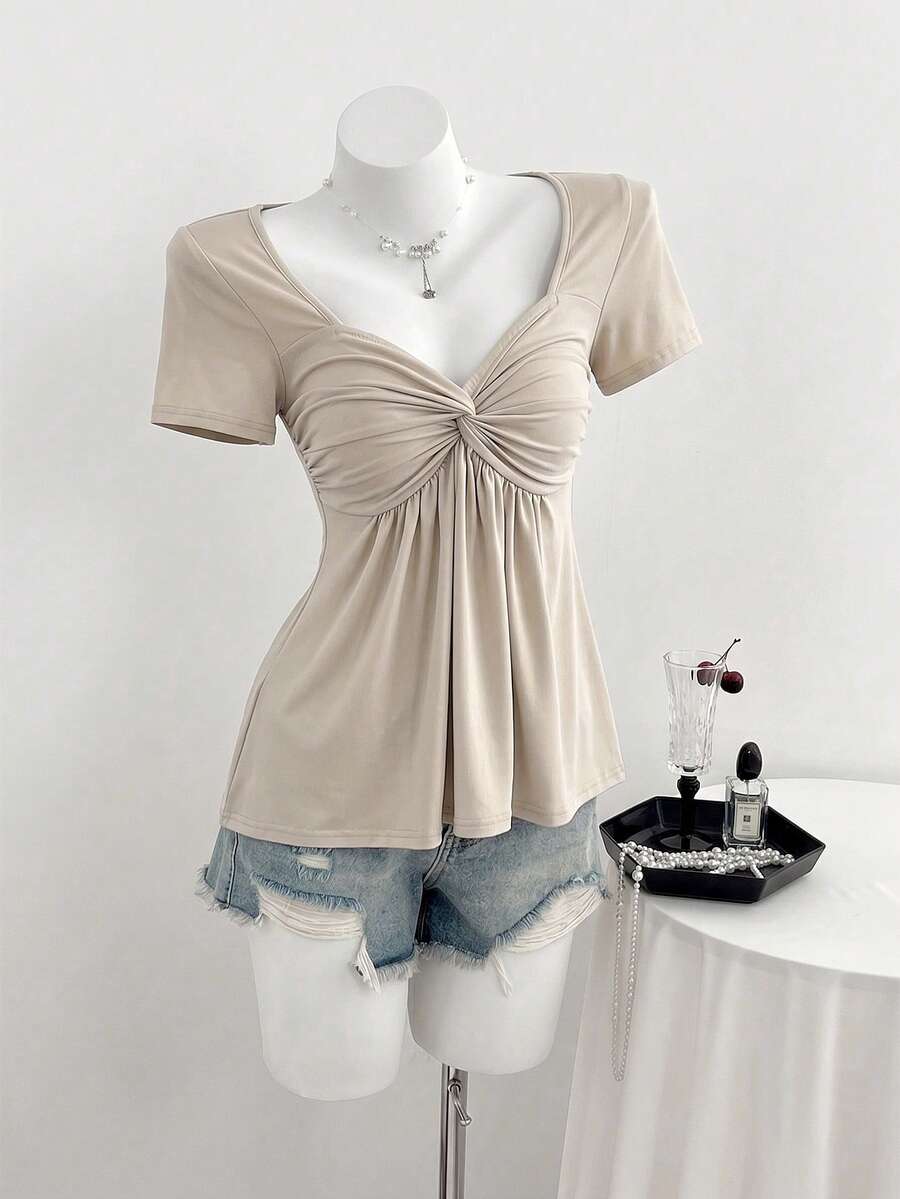 Women's short sleeve V-neck T-shirt featuring a front twist knot detail and slim fit.