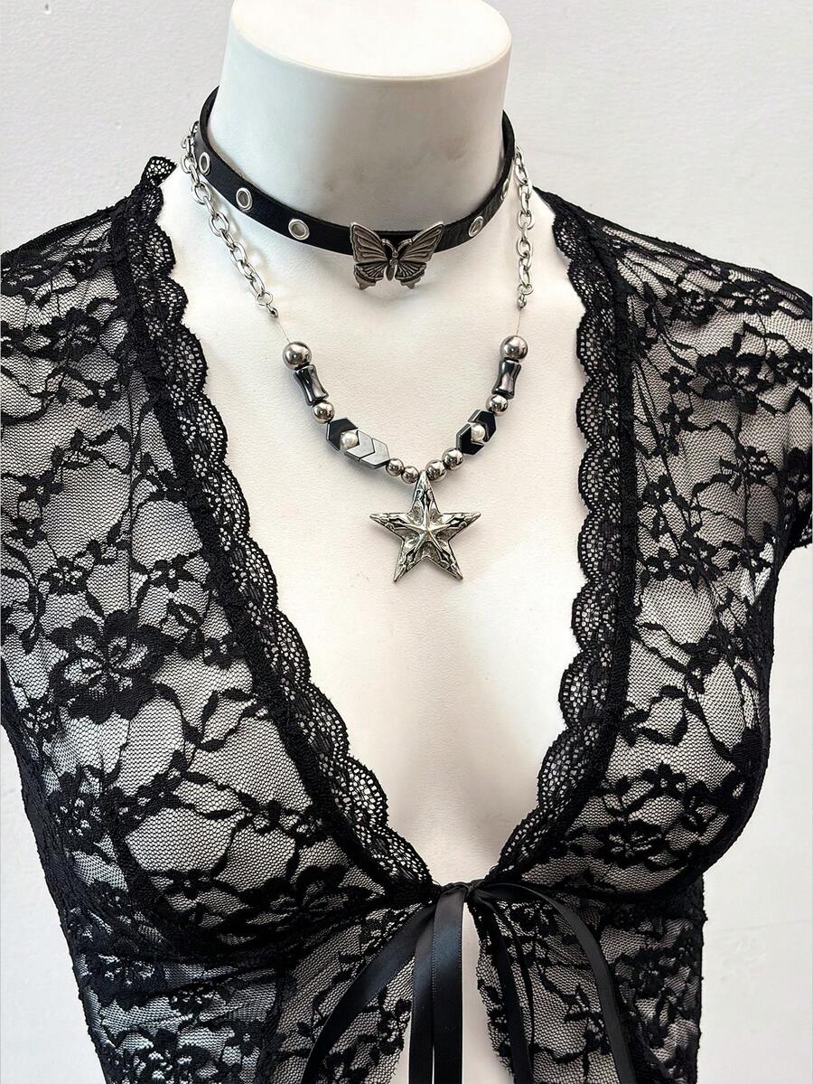 Women's semi-sheer deep V-neck top featuring cap sleeves, contrast lace trimming, and a lace-up front detail.