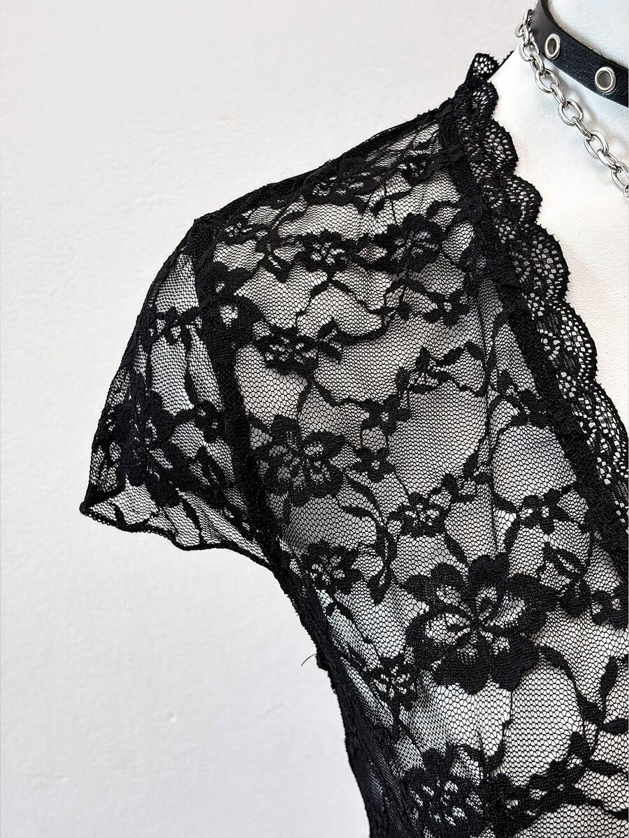 Women's semi-sheer deep V-neck top featuring cap sleeves, contrast lace trimming, and a lace-up front detail.