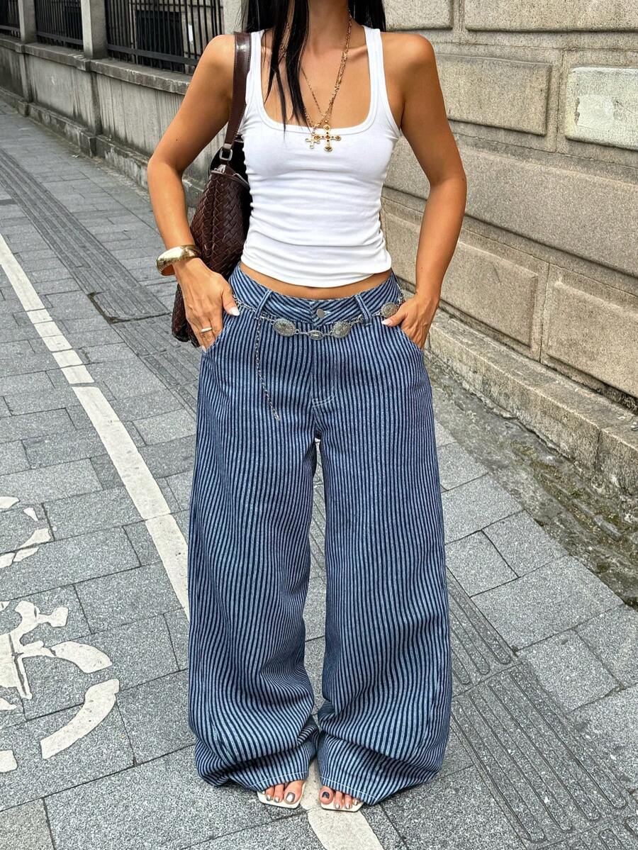 Front view of women's loose wide leg denim jeans featuring a mid waist, classic front pockets, and a zipper fly closure.