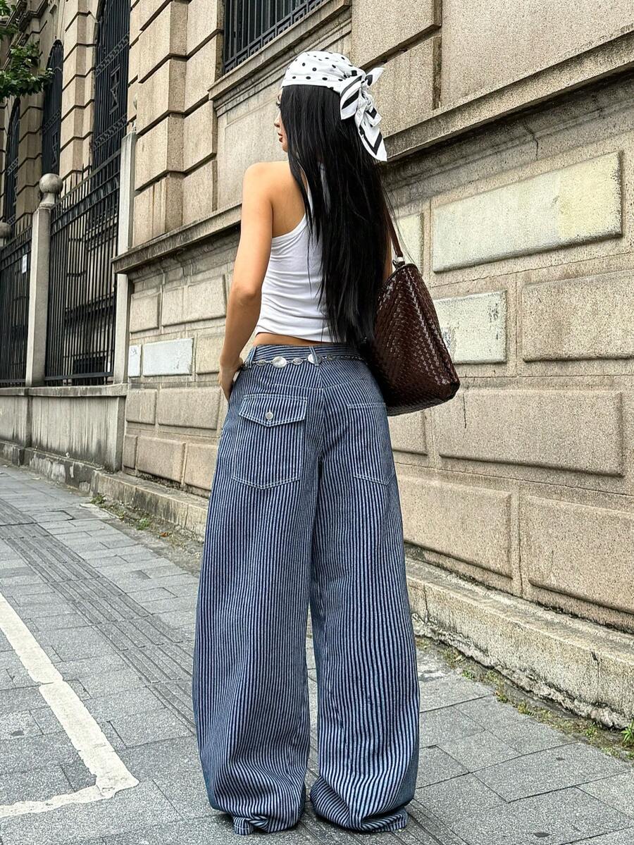 Front view of women's loose wide leg denim jeans featuring a mid waist, classic front pockets, and a zipper fly closure.