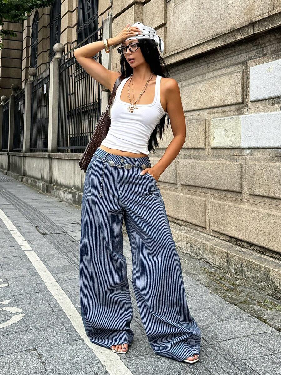 Front view of women's loose wide leg denim jeans featuring a mid waist, classic front pockets, and a zipper fly closure.