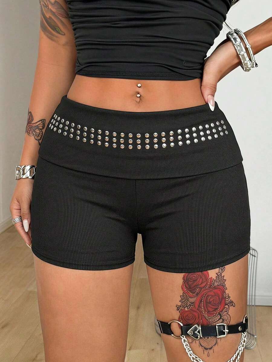 Women's black studded mini shorts crafted from stretch knitted fabric featuring an elastic waistband and skinny fit.