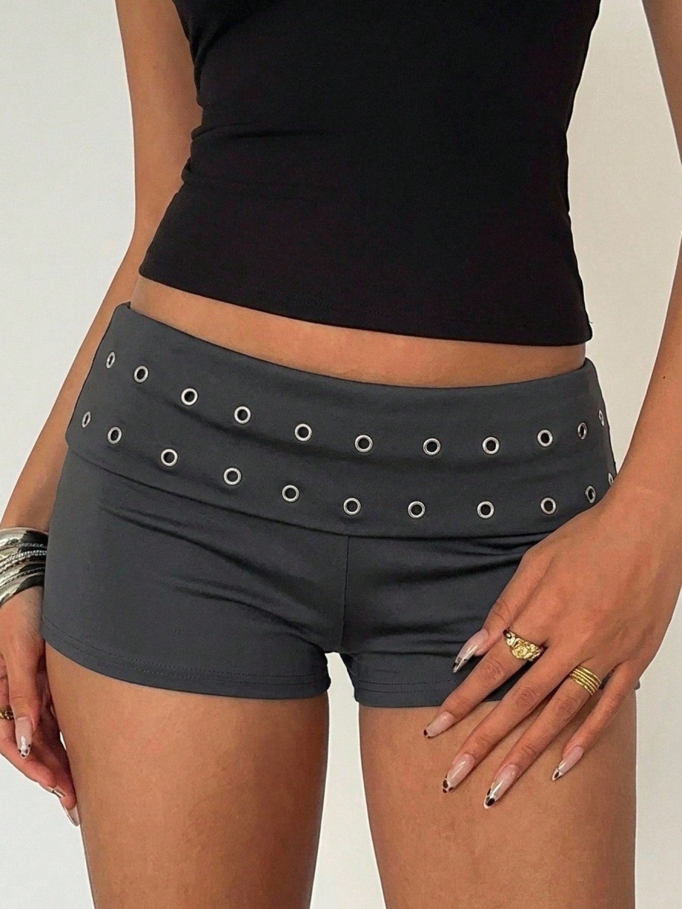 Women's ultra low waist mini shorts with rhinestone studded detailing, skinny fit, and mini length.
