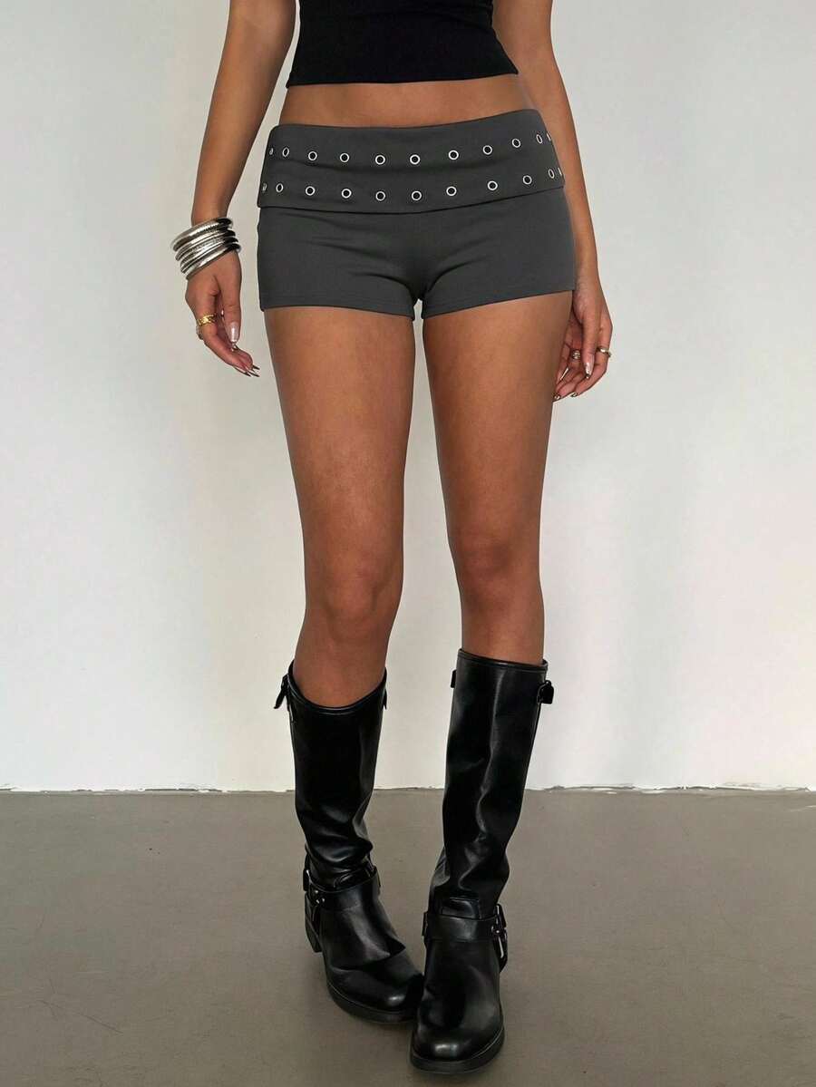 Women's studded PU ultra low waist mini shorts with zipper fly closure, skinny fit, mini length, and plain unlined design.