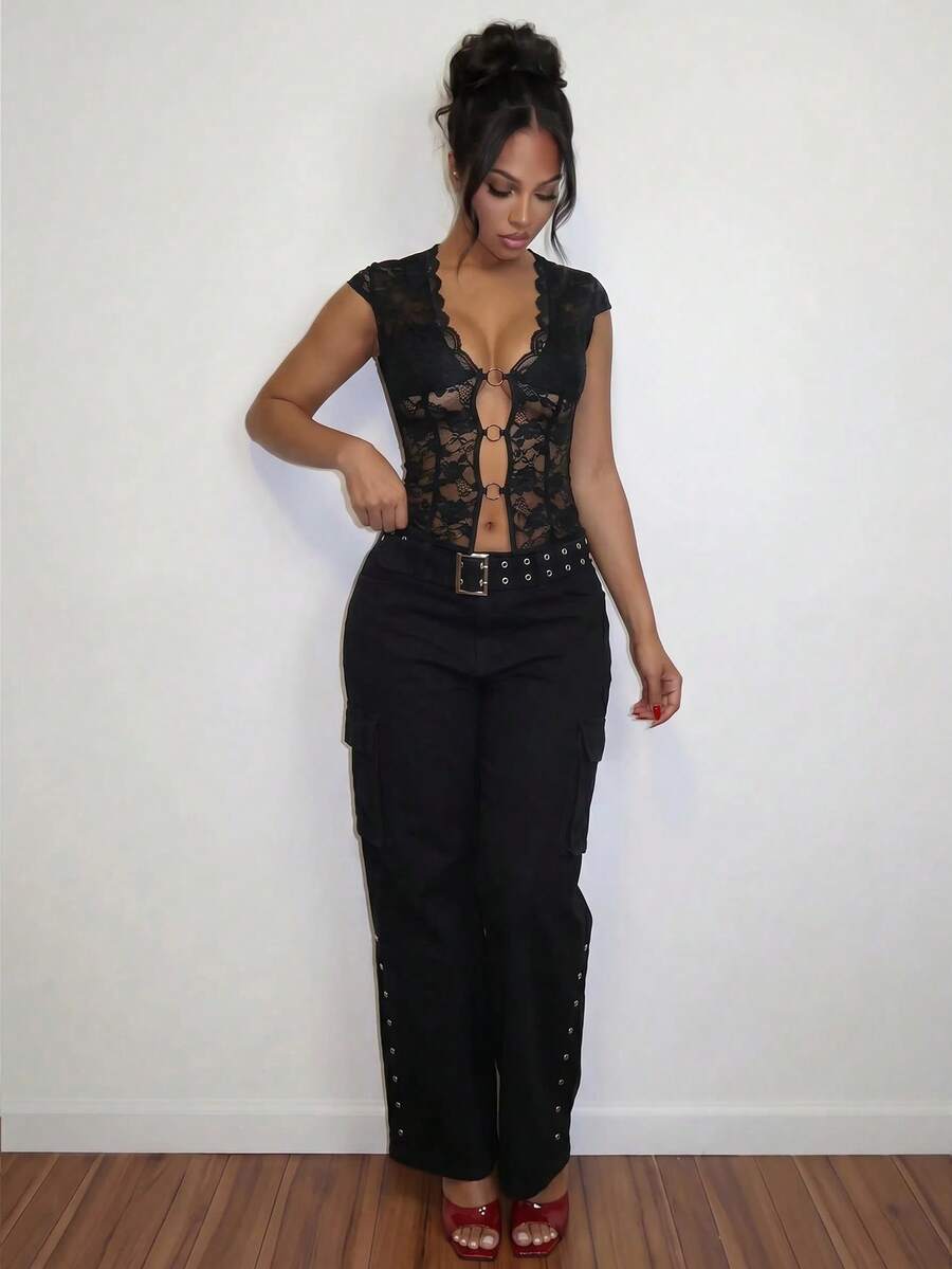Women's black slim fit semi-sheer blouse featuring contrast lace detailing, a deep V hollow design with ring accent, asymmetrical hem, and cap sleeves.