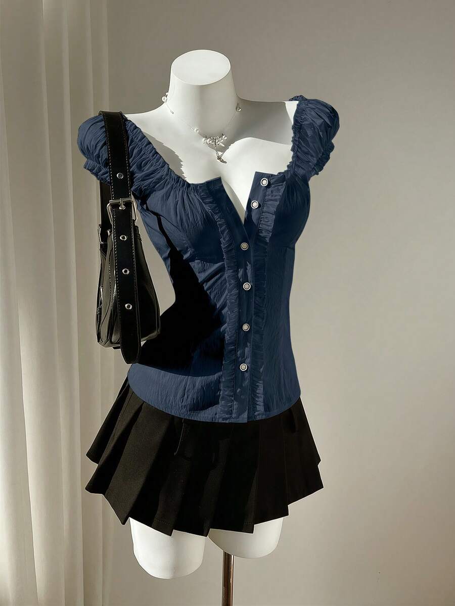 Women's black off-shoulder cap sleeve blouse with ruffled detailing and a tie-back design.