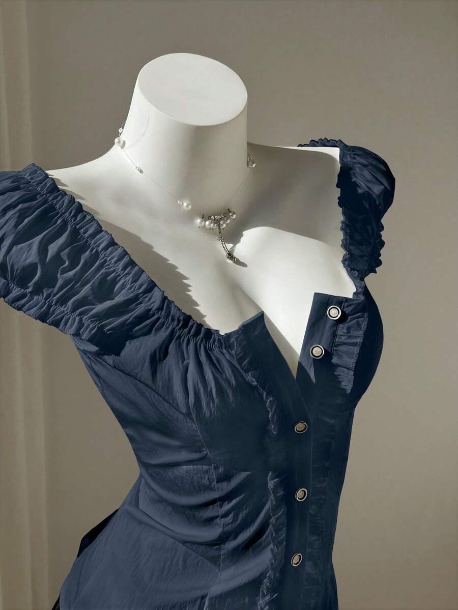 Women's black off-shoulder cap sleeve blouse with ruffled detailing and a tie-back design.