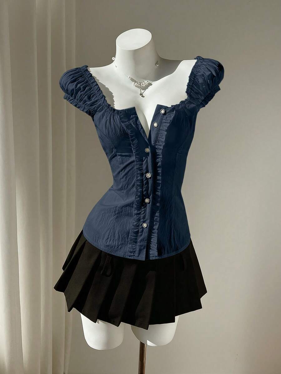 Women's black off-shoulder cap sleeve blouse with ruffled detailing and a tie-back design.