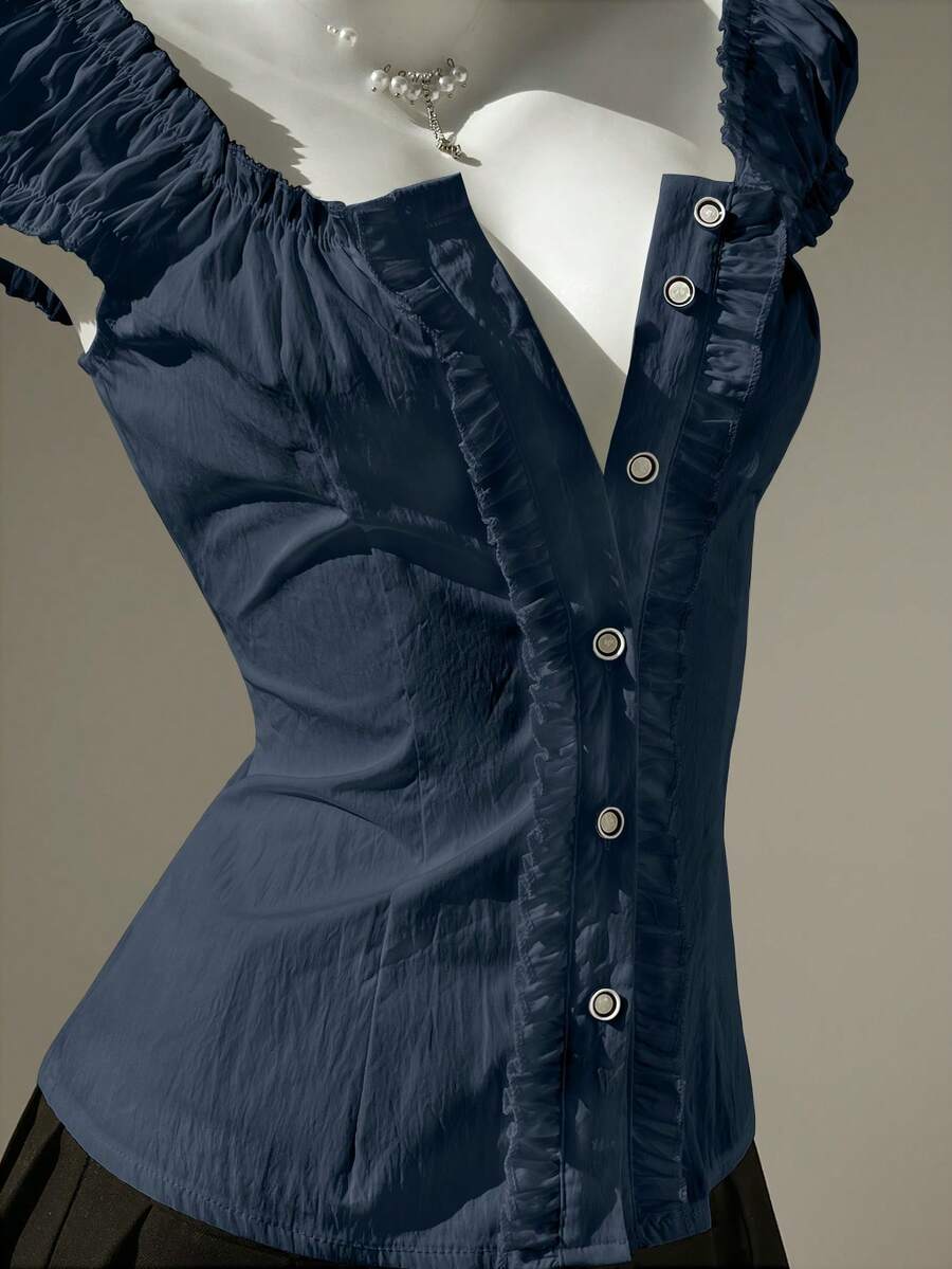 Women's black off-shoulder cap sleeve blouse with ruffled detailing and a tie-back design.