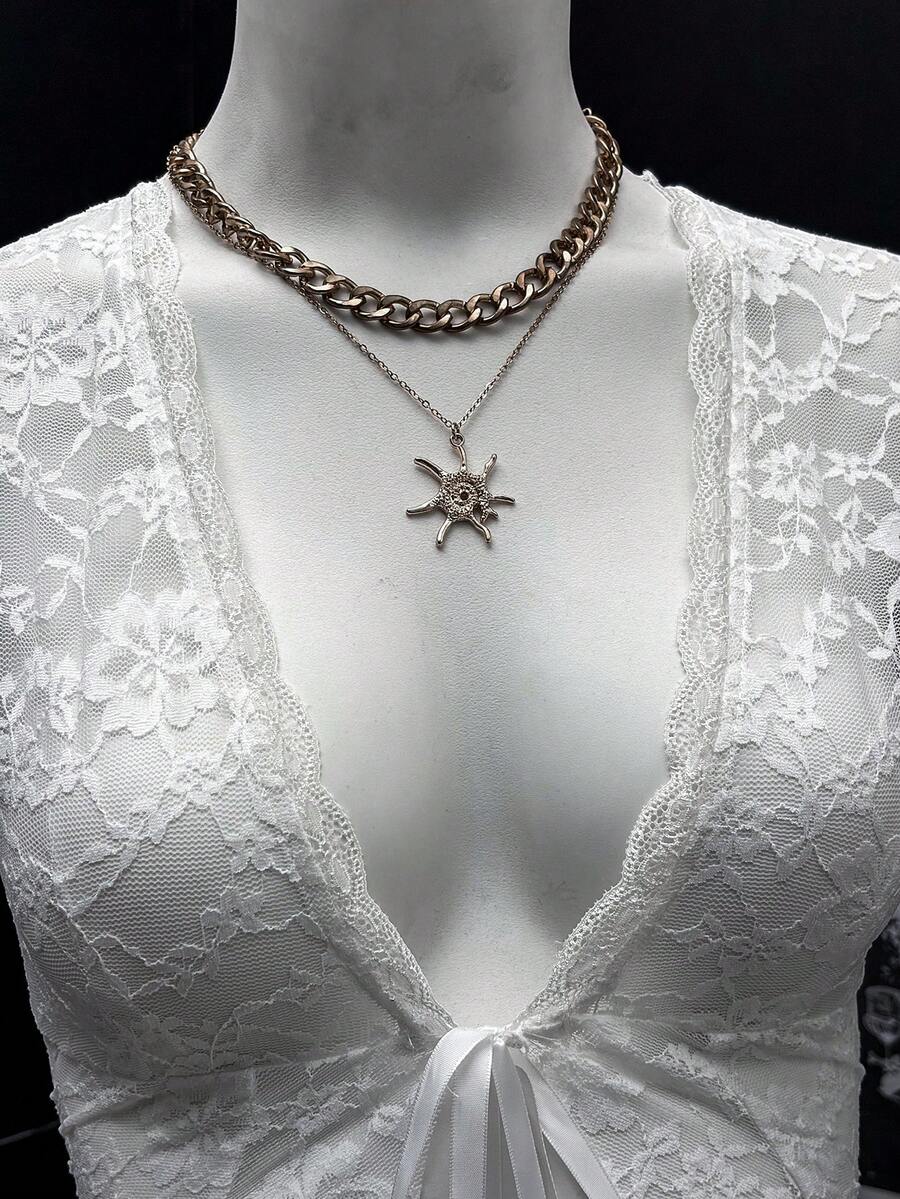 Women's semi-sheer deep V-neck top featuring cap sleeves, contrast lace trimming, and a lace-up front detail.