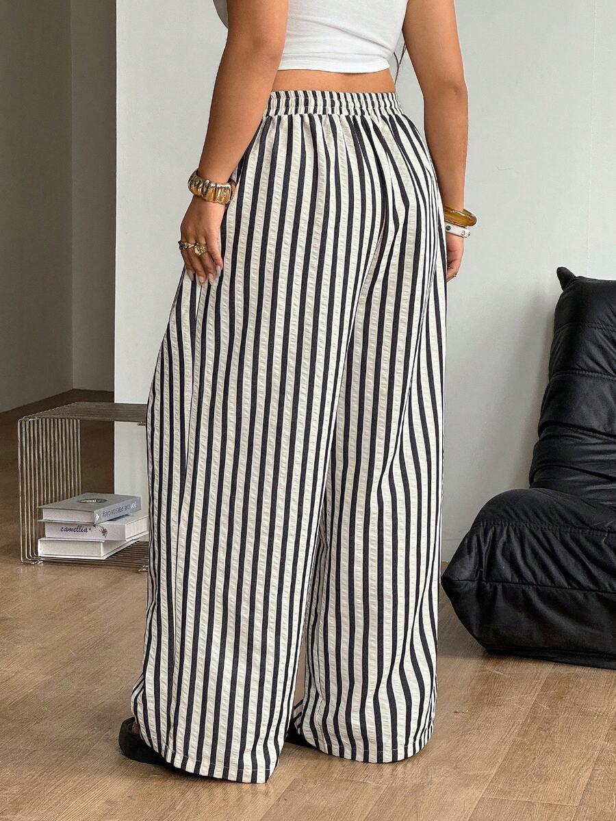 Women's loose straight leg cotton pants featuring a high waist with an adjustable drawstring knot and functional side pockets.