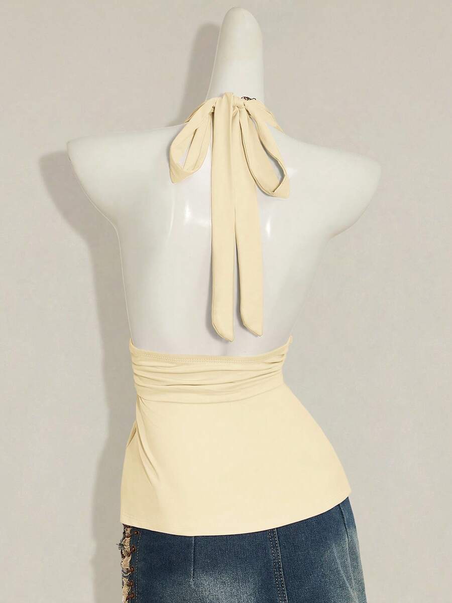 Women's backless halter babydoll tank top featuring a square neckline, slim fit silhouette, and a flared ruffle hem.