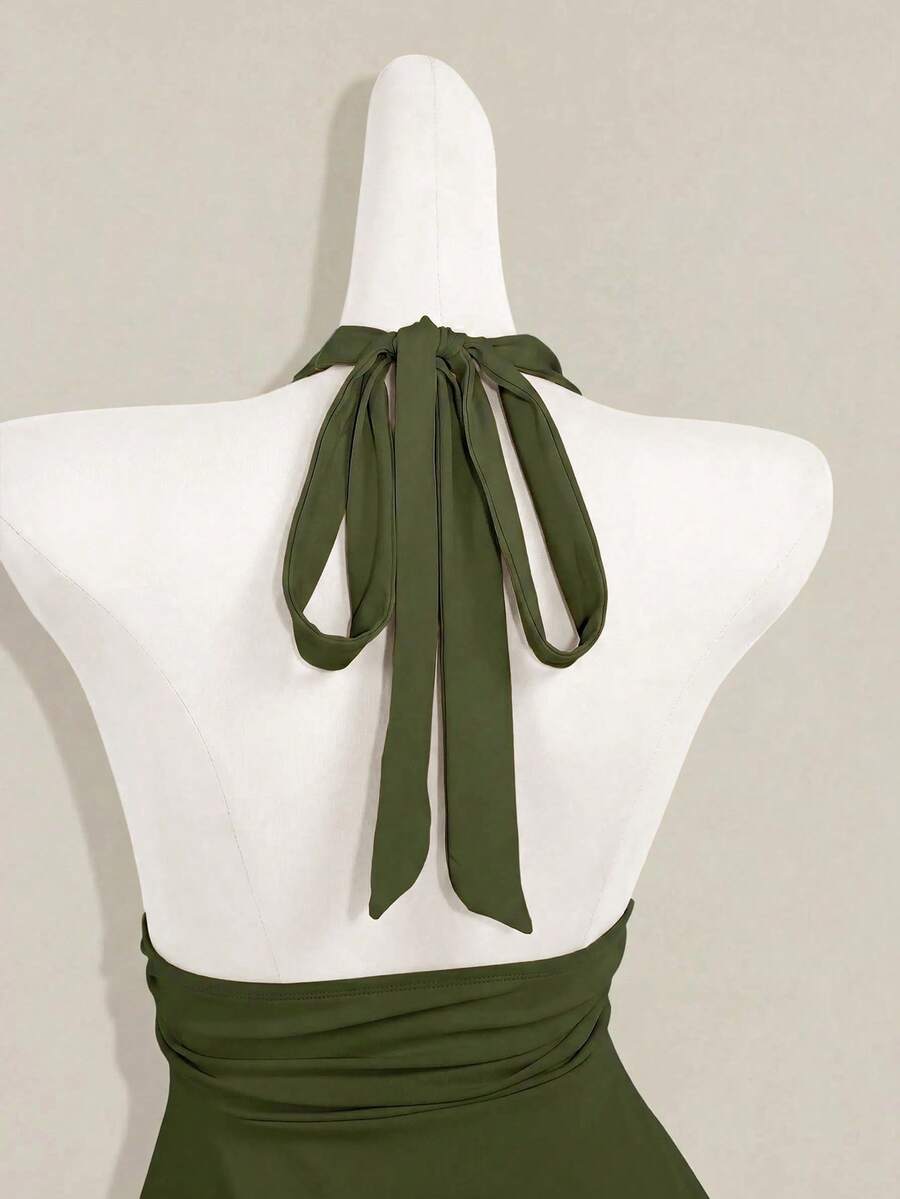 Women's backless halter babydoll tank top featuring a square neckline, slim fit silhouette, and a flared ruffle hem.