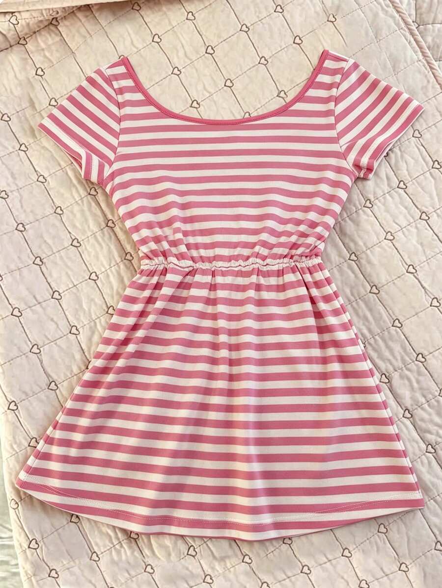 Women's hot pink short sleeve vacation top featuring a heart shape neckline, twist detail, and raglan sleeves.