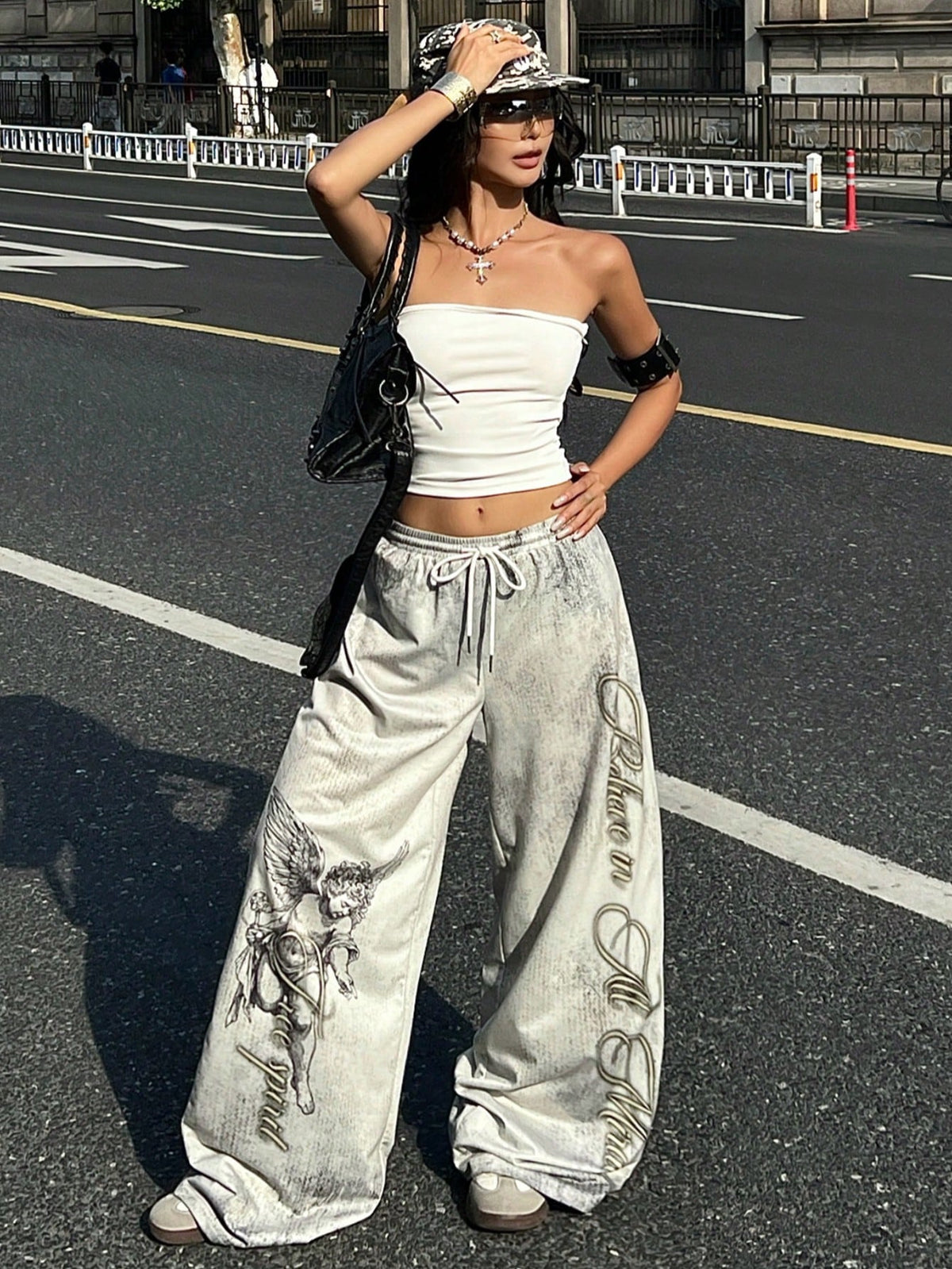 Women's loose fit wide leg graphic sweatpants in light grey with an elastic drawstring waistband