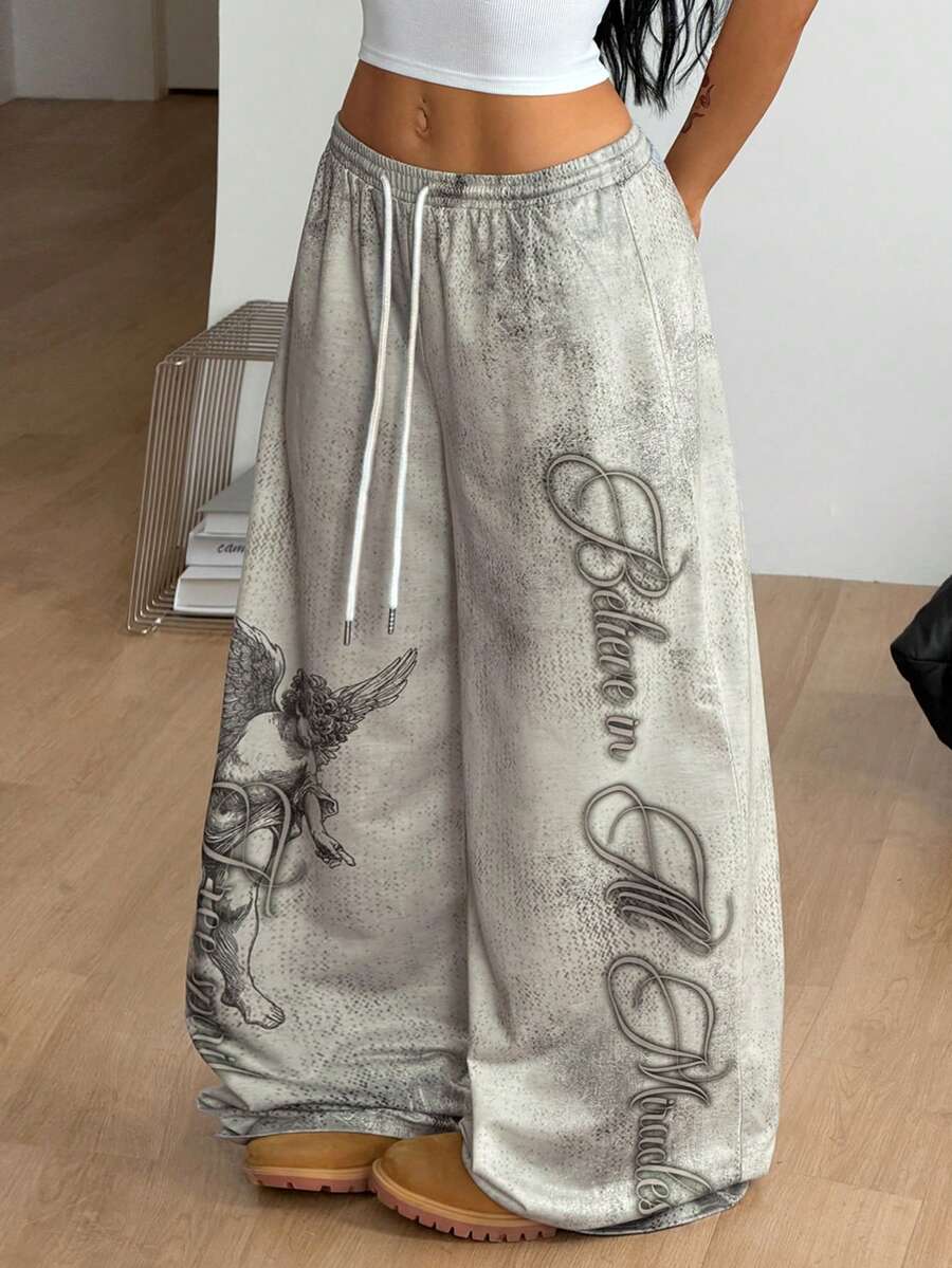 Women's loose fit wide leg graphic sweatpants in light grey with an elastic drawstring waistband