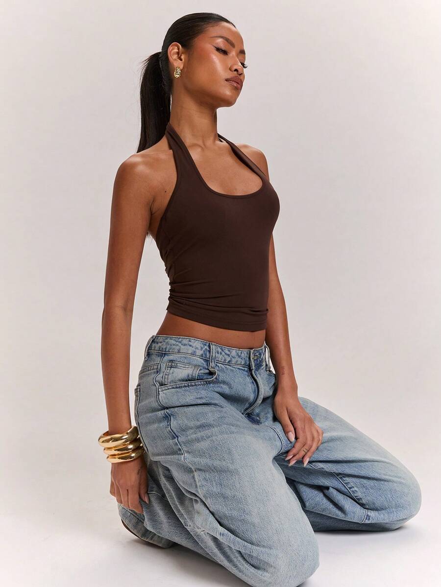 Women's knitted halter tank top with backless twisted knot design and asymmetrical hem
