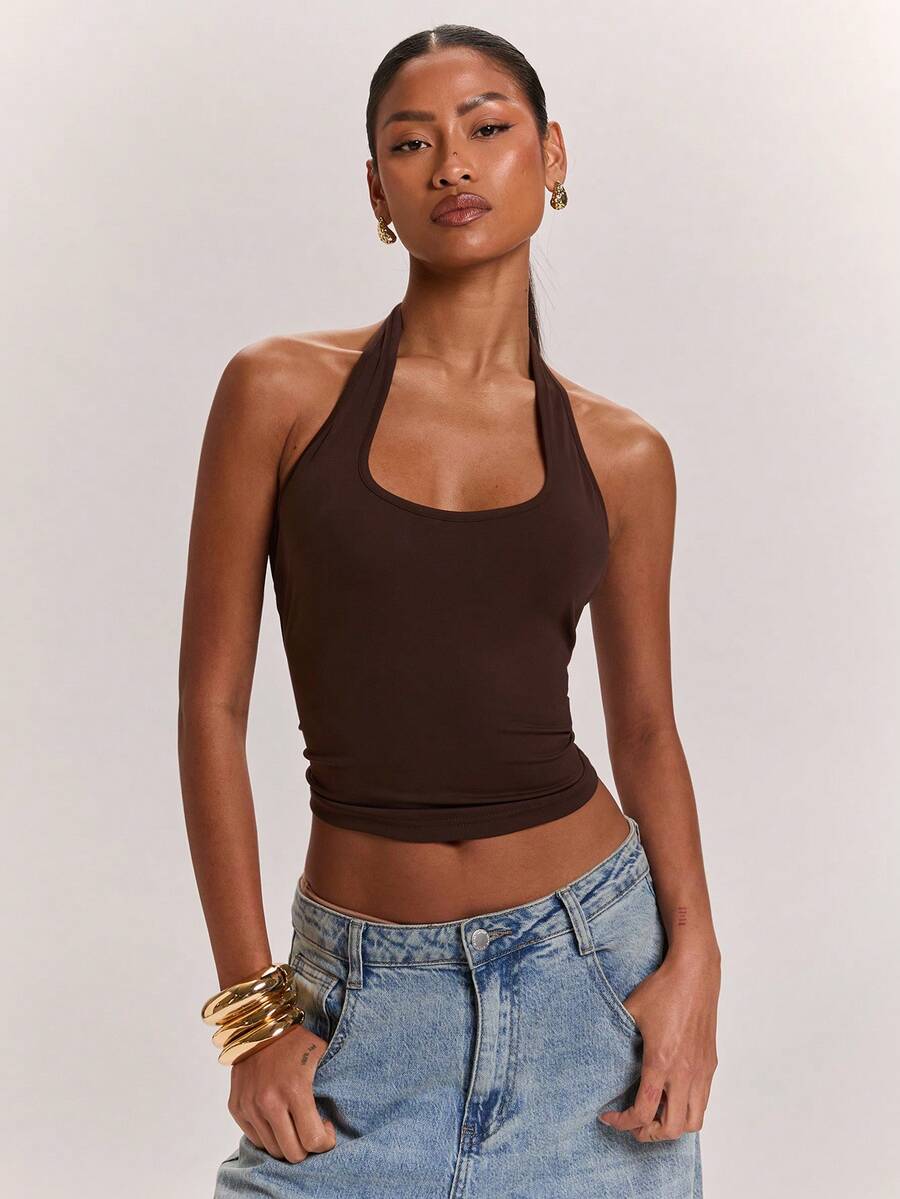 Women's knitted halter tank top with backless twisted knot design and asymmetrical hem