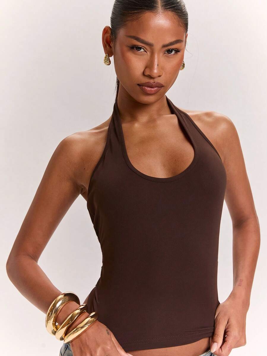Women's knitted halter tank top with backless twisted knot design and asymmetrical hem