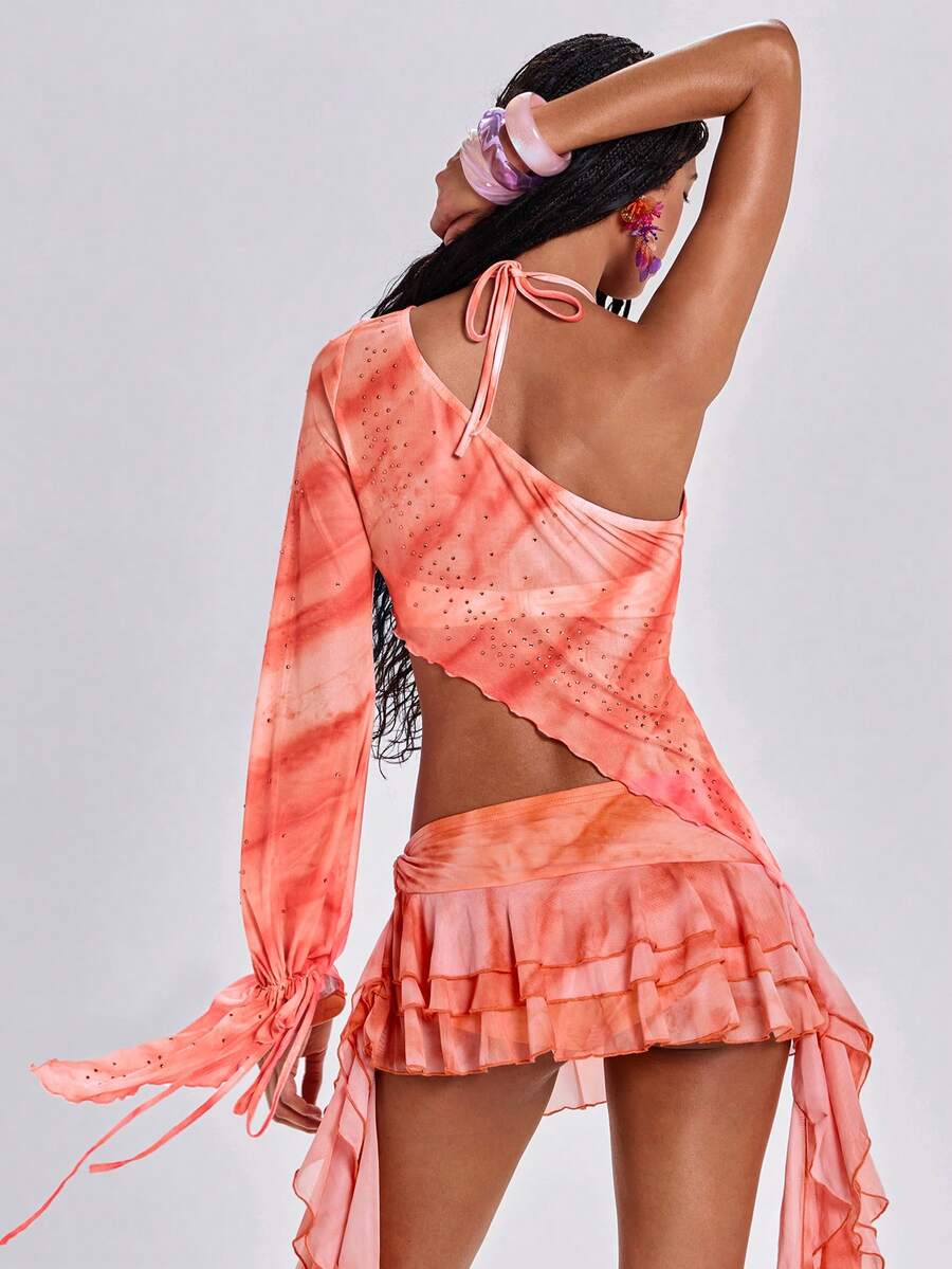 Women's one shoulder crop top featuring an asymmetrical long sleeve, colorful print, and sparkling rhinestone embellishments.