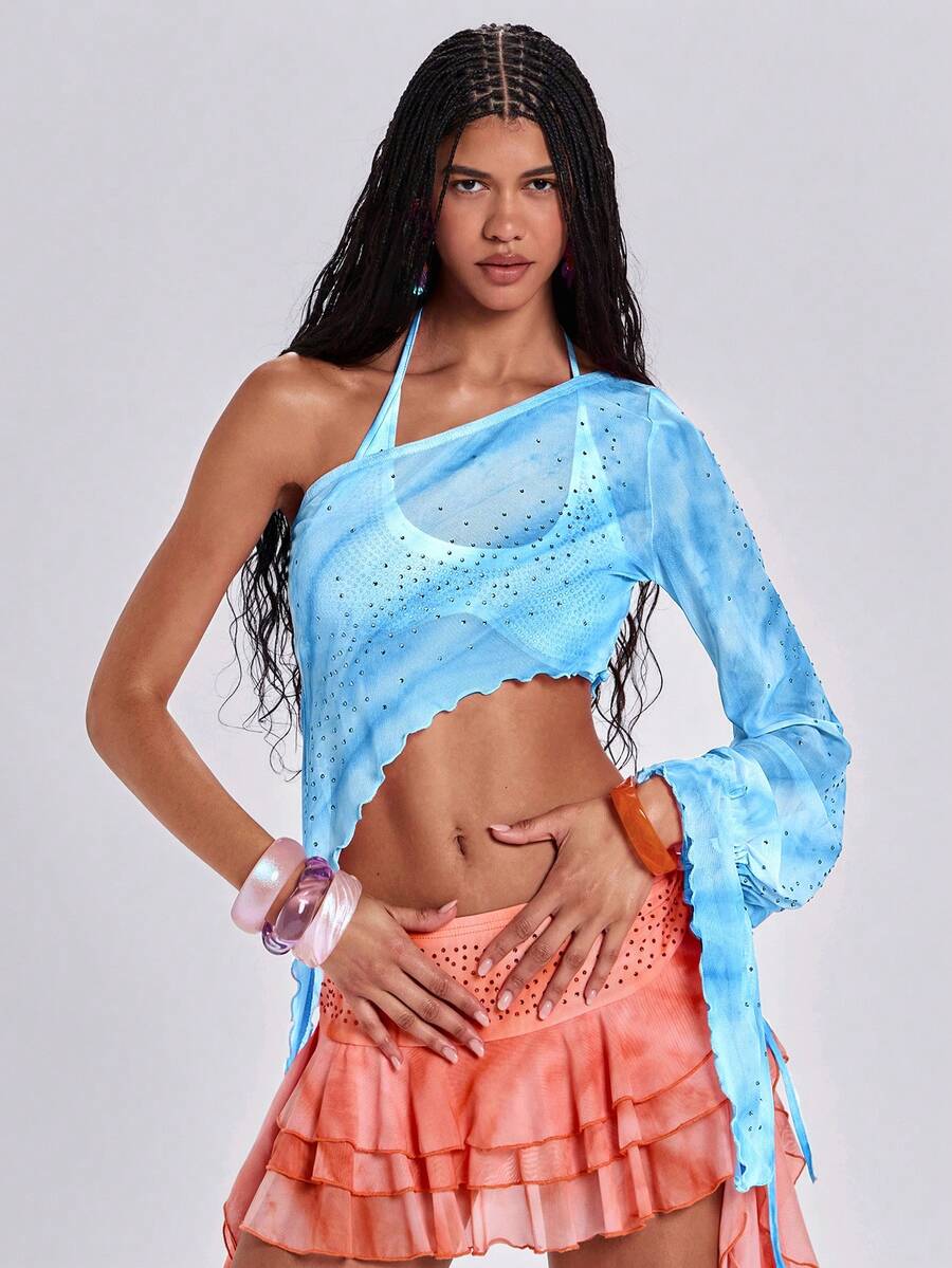 Women's one shoulder crop top featuring an asymmetrical long sleeve, colorful print, and sparkling rhinestone embellishments.