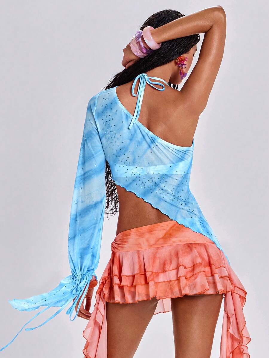 Women's one shoulder crop top featuring an asymmetrical long sleeve, colorful print, and sparkling rhinestone embellishments.