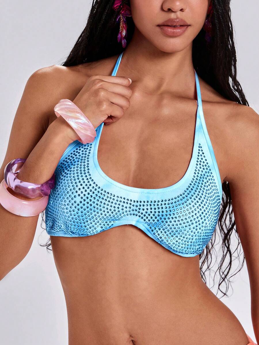 Women's one shoulder crop top featuring an asymmetrical long sleeve, colorful print, and sparkling rhinestone embellishments.