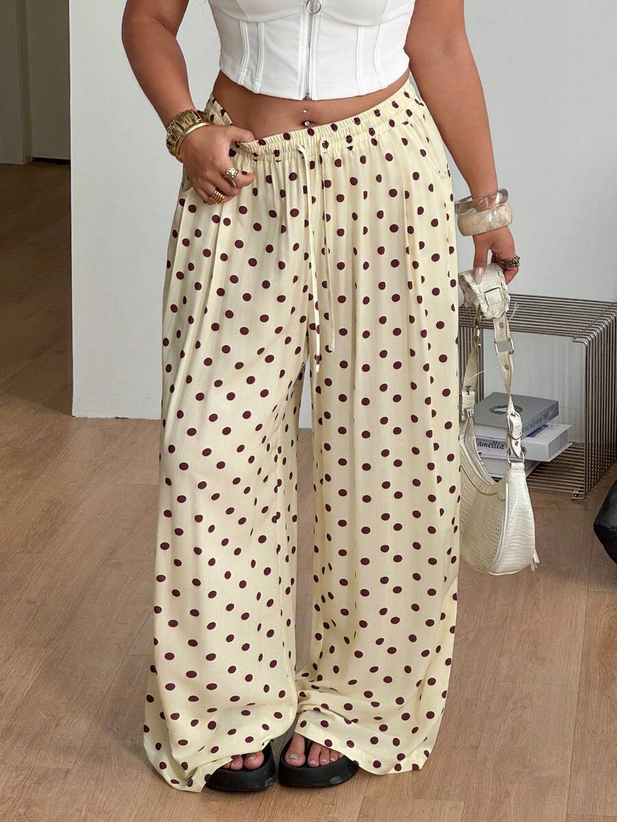 Women's loose straight leg cotton pants featuring a high waist with an adjustable drawstring knot and functional side pockets.