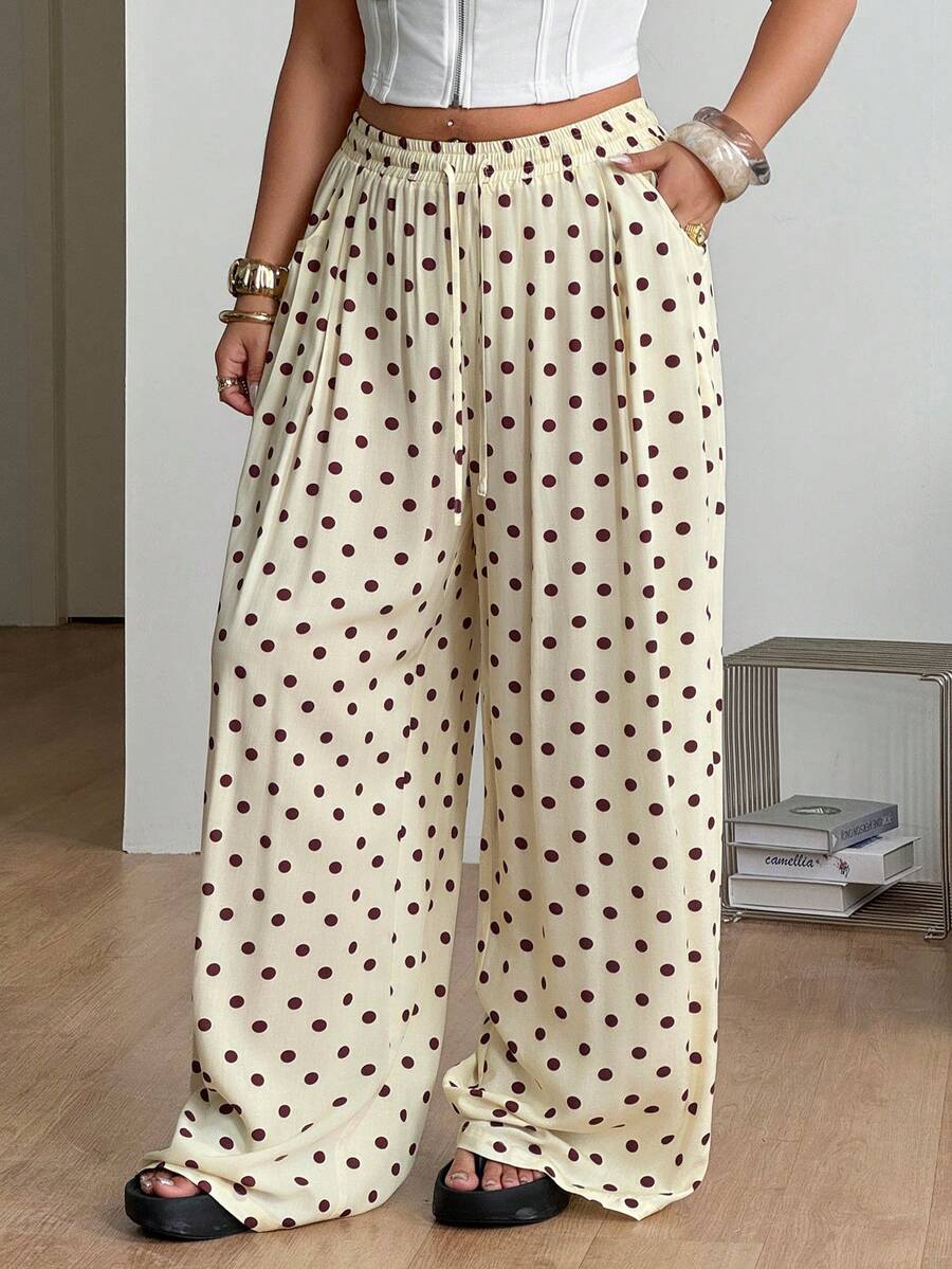 Women's loose straight leg cotton pants featuring a high waist with an adjustable drawstring knot and functional side pockets.