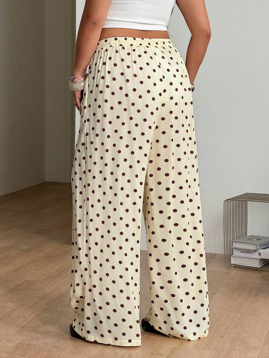 Women's loose straight leg cotton pants featuring a high waist with an adjustable drawstring knot and functional side pockets.