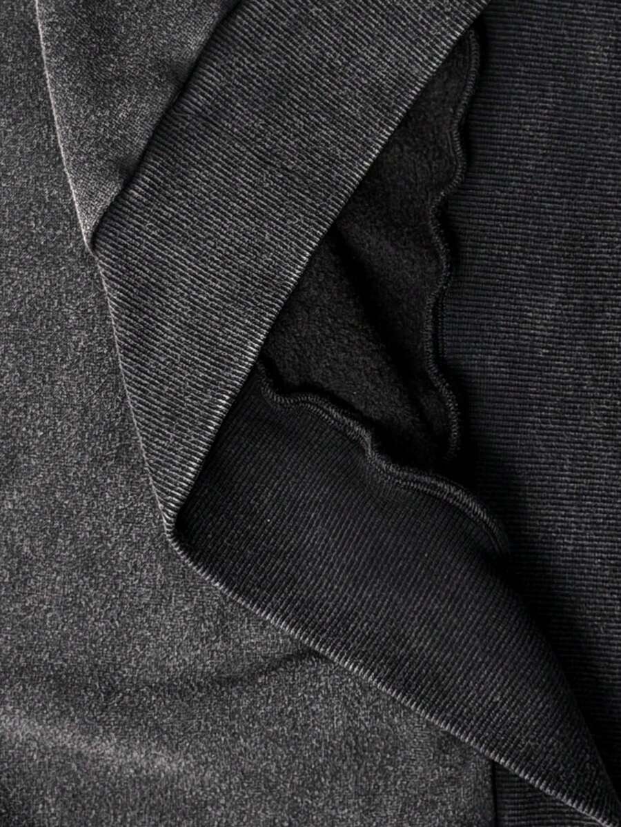 Women's oversized dark grey long sleeve sweatshirt featuring an asymmetrical boat neckline with grommet eyelet details and drop shoulders.
