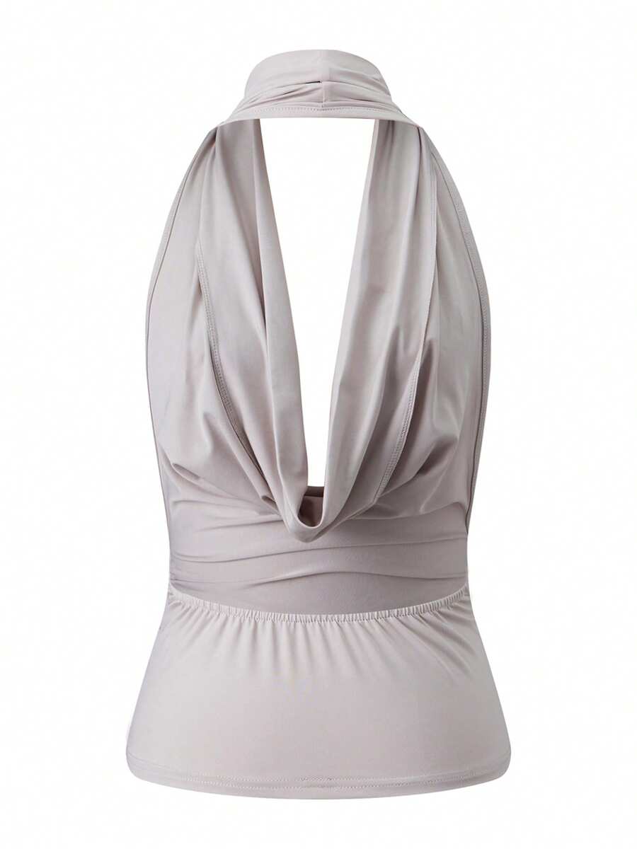 Women's backless halter crop top featuring a draped cowl front, knot detail, and slim fit design.