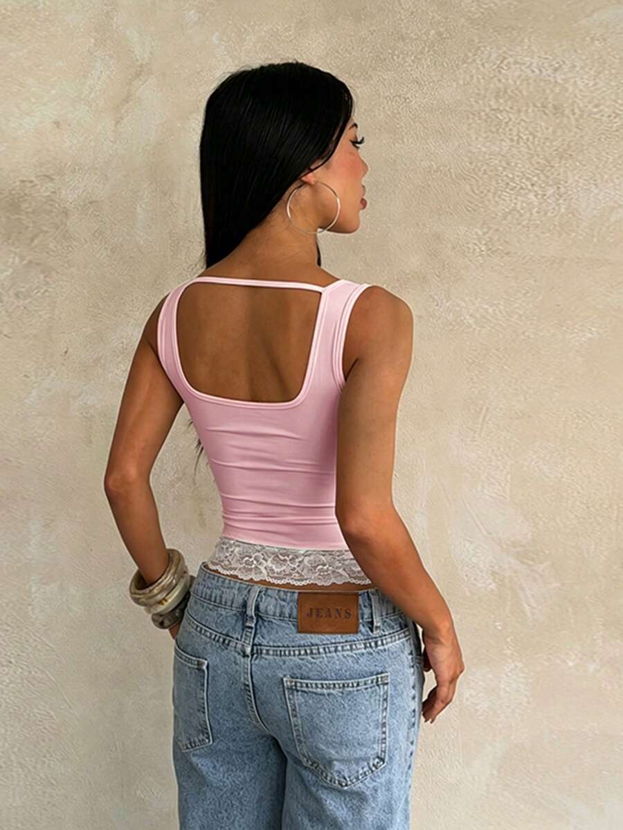 Women's white sleeveless crop tank top with contrast lace details, strap neckline, and graphic plant pattern in a slim fit.