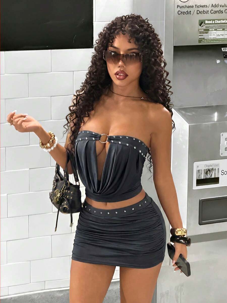 Women's Y2K two-piece set with a strapless bandeau crop top and matching studded mini skirt in a slim fit.