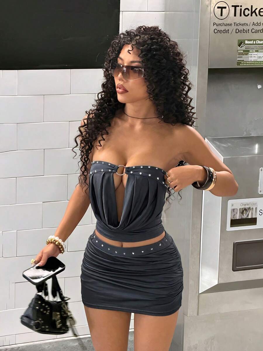 Women's Y2K two-piece set with a strapless bandeau crop top and matching studded mini skirt in a slim fit.