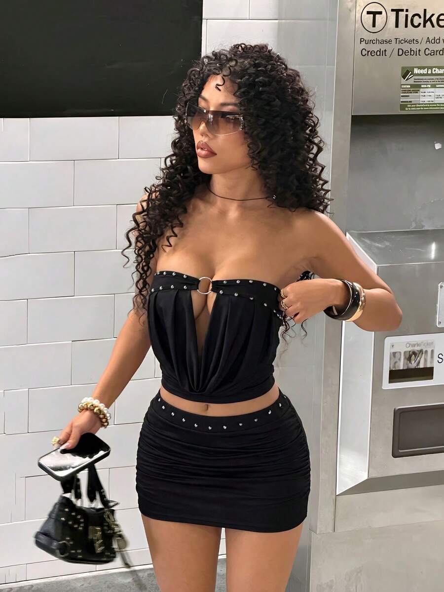 Women's Y2K two-piece set with a strapless bandeau crop top and matching studded mini skirt in a slim fit.