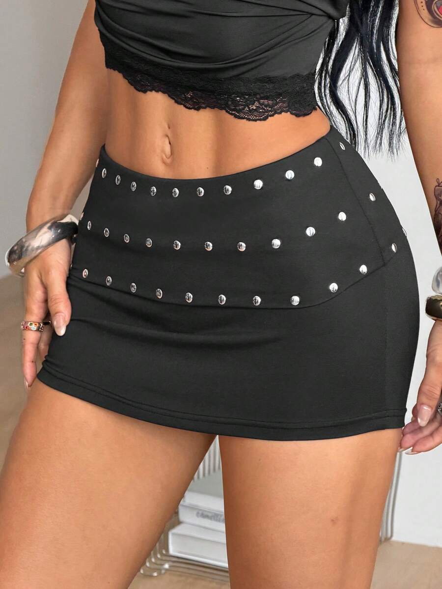 Women's black ultra low waist mini pencil skirt with rhinestone studded detail, skinny fit, and stretchy polyester fabric.